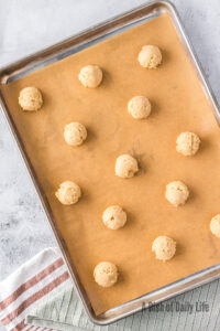 cookie dough balls on cookie sheet, unbaked