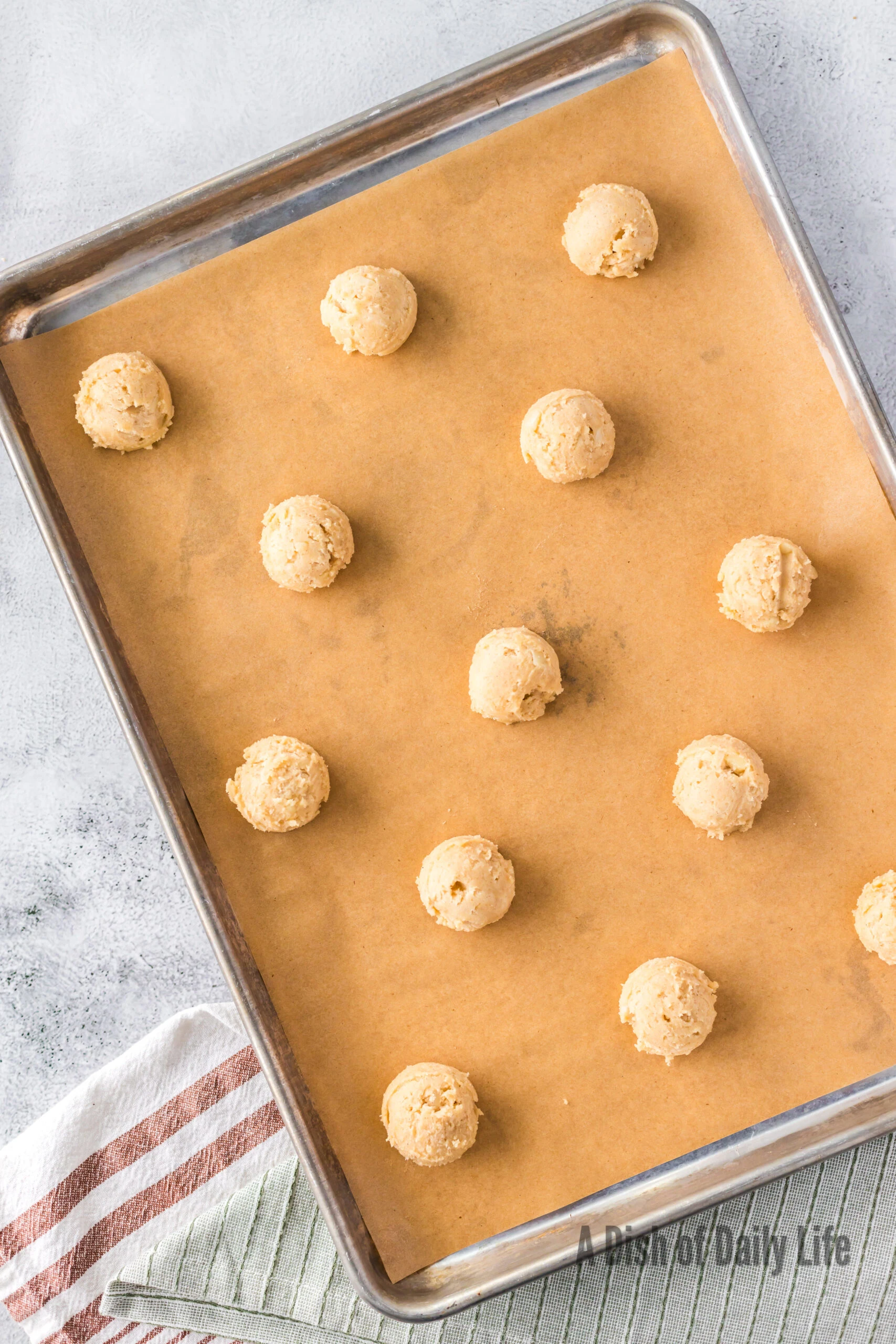 cookie dough balls on cookie sheet, unbaked