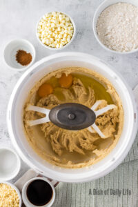Butter, sugars and eggs in a mixing bowl.