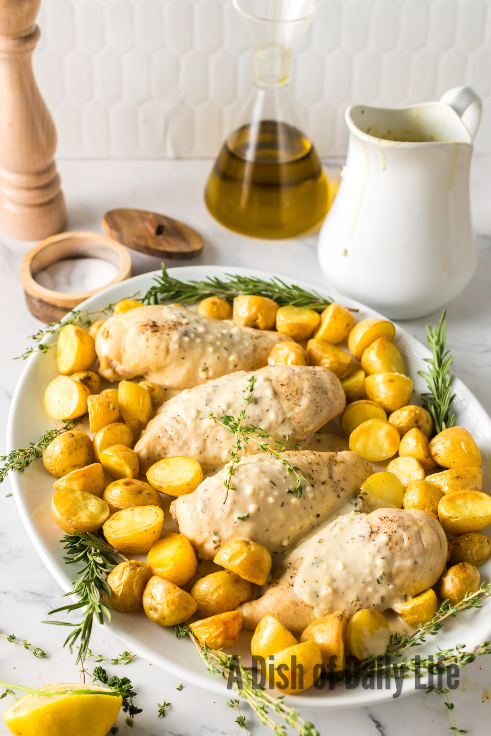 roasted chicken with sauce and roasted potatoes on a platter
