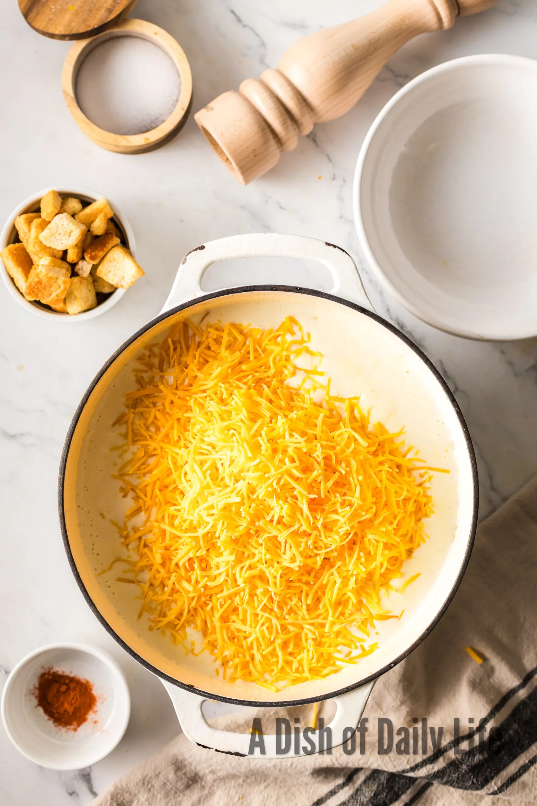 cheese added to soup pot.