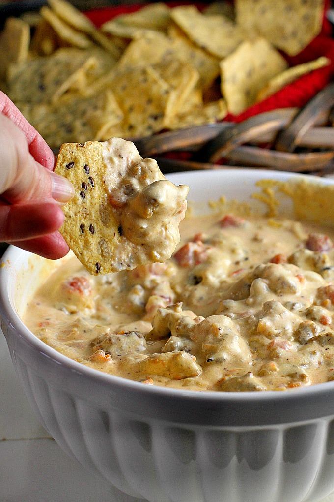 This Crock Pot Sausage Cheese Dip is an easy-to-make crowd pleaser for game day! Only minutes of prep work, then throw all your ingredients in the slow cooker for an hour. Great with chips and veggies!