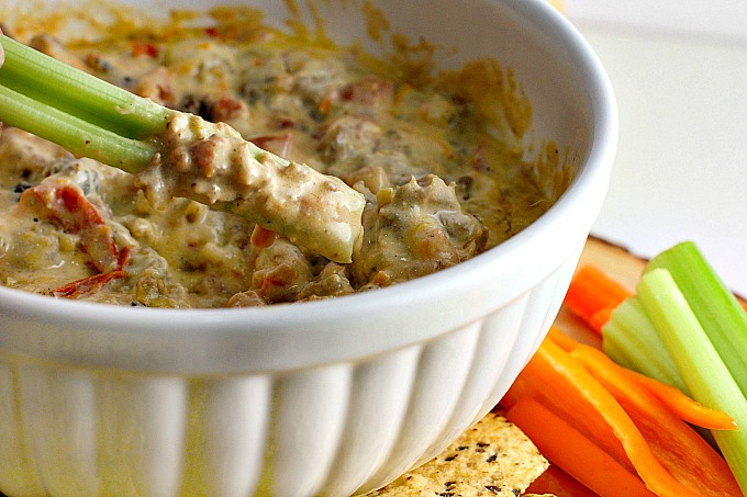 This Crock Pot Sausage Cheese Dip is an easy-to-make crowd pleaser for game day! Only minutes of prep work, then throw all your ingredients in the slow cooker for an hour. Great with chips and veggies!