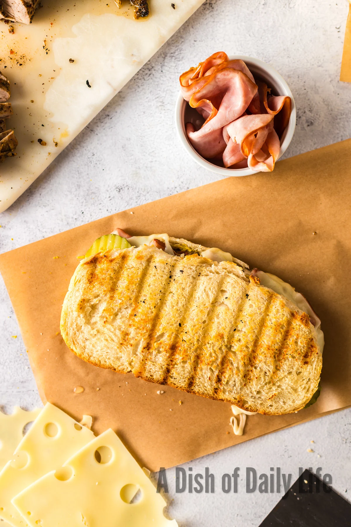 Grilled sandwich on parchment paper.