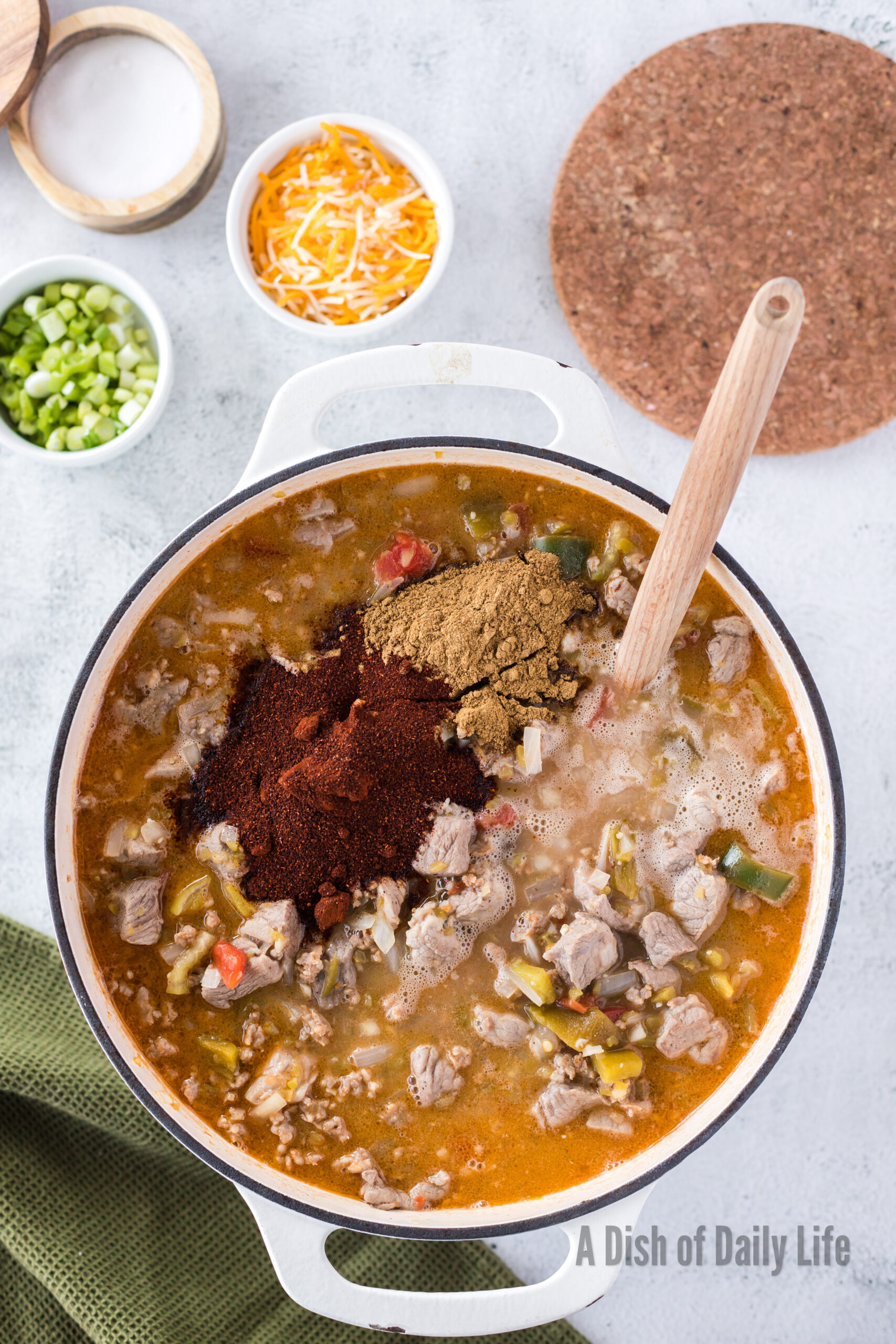 chili powder and cumin added to soup pot