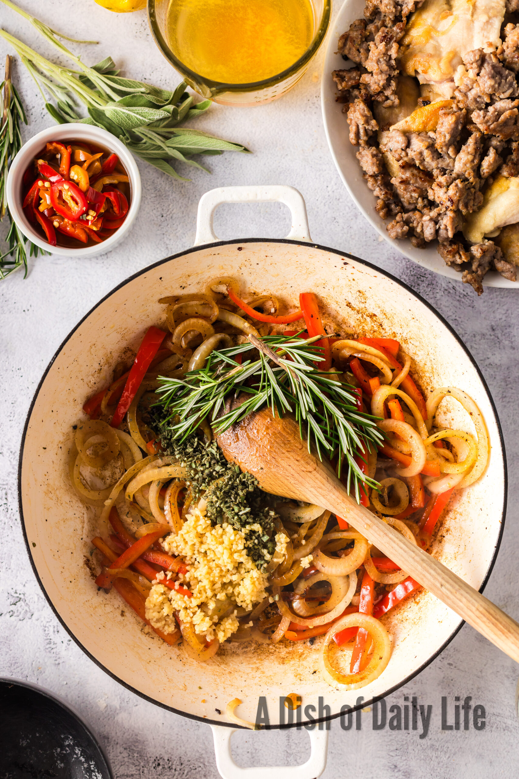 Garlic, sage and rosemary added to peppers and onions.