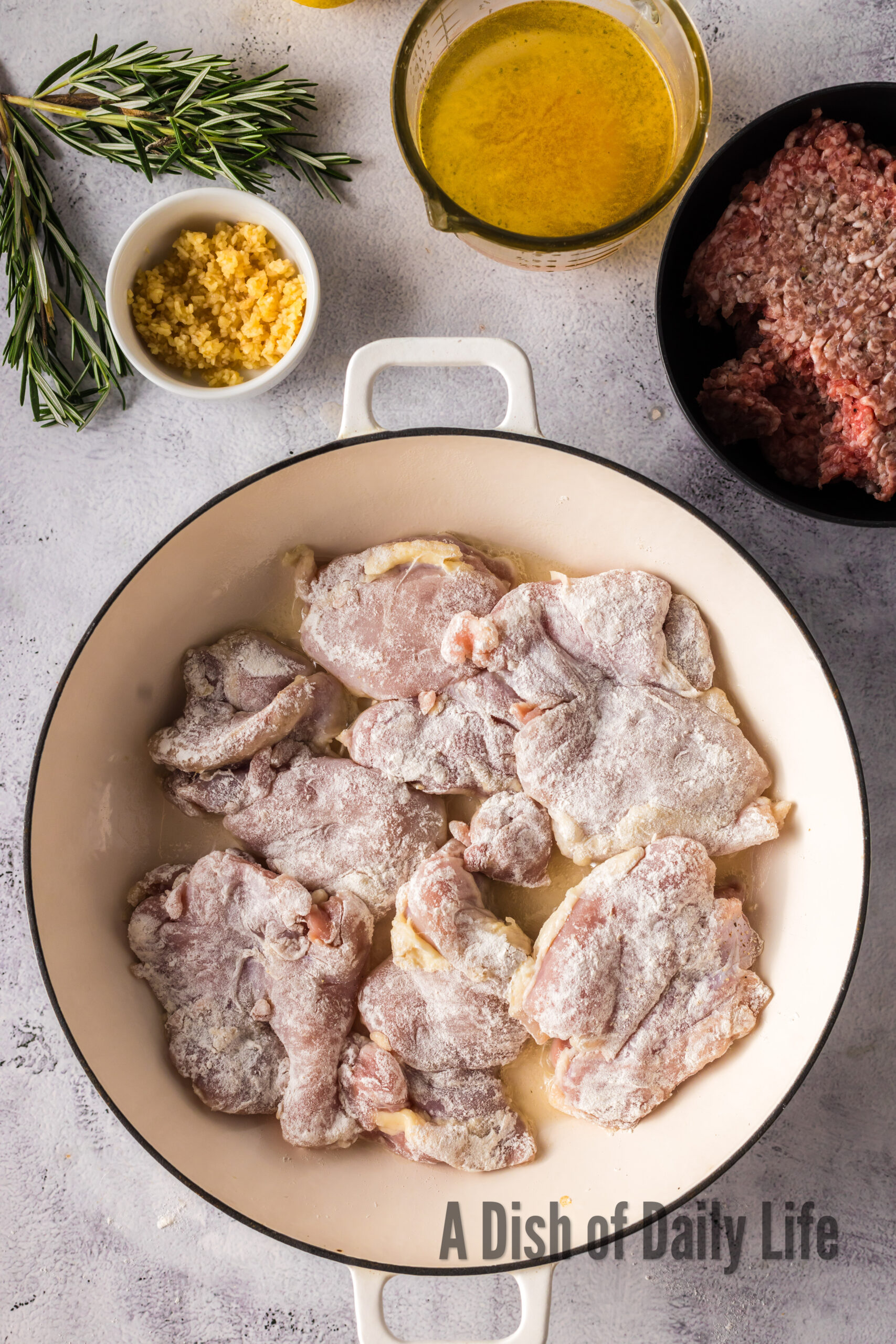 Chicken thighs cooking in a dutch oven.