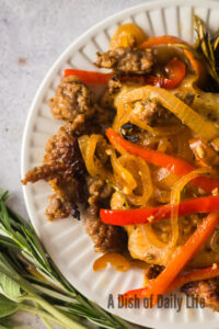 zoomed in image of Chicken Scarpariello on a plate.