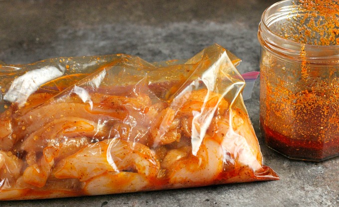 chicken marinating in fajita seasoning mix image