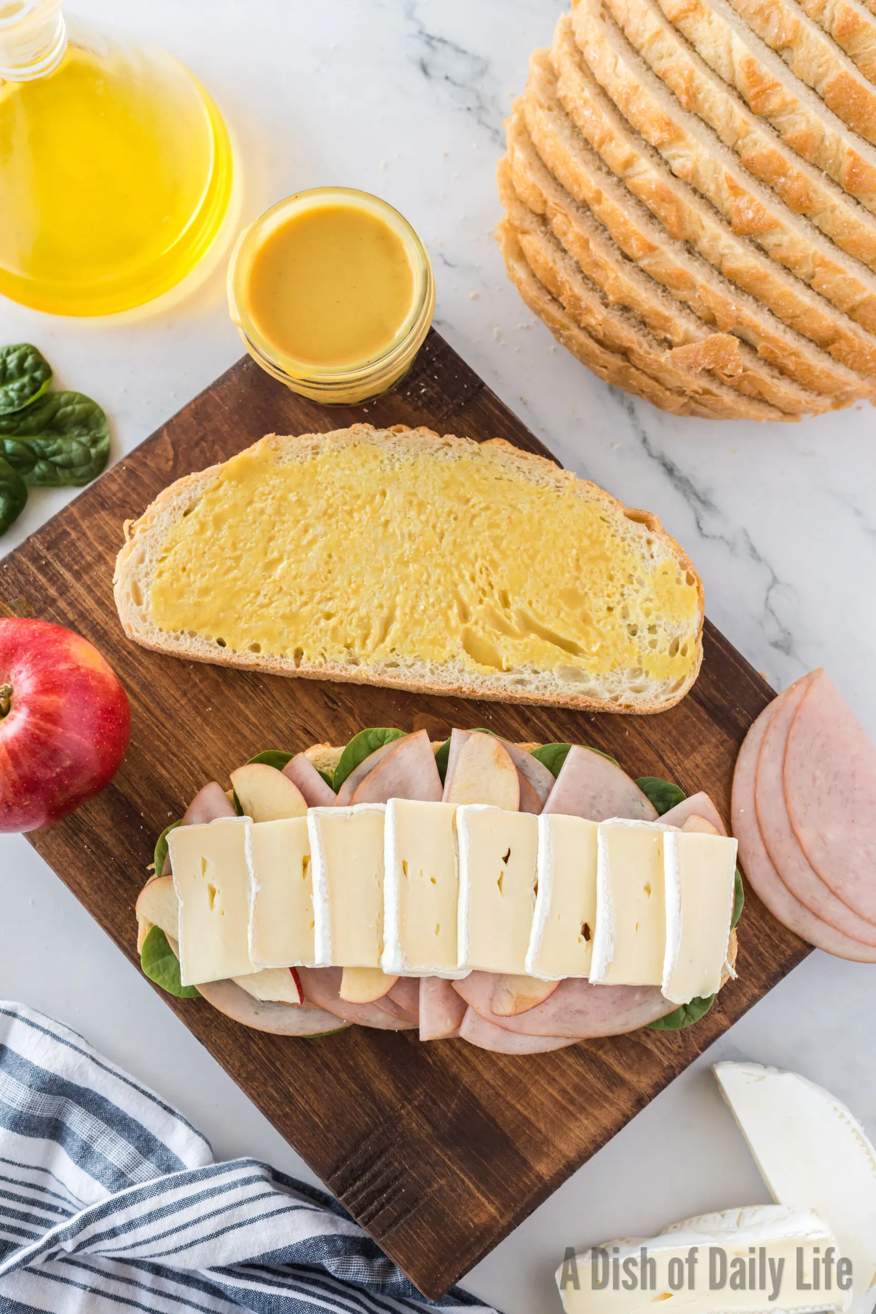 Assembling a ham and brie panini