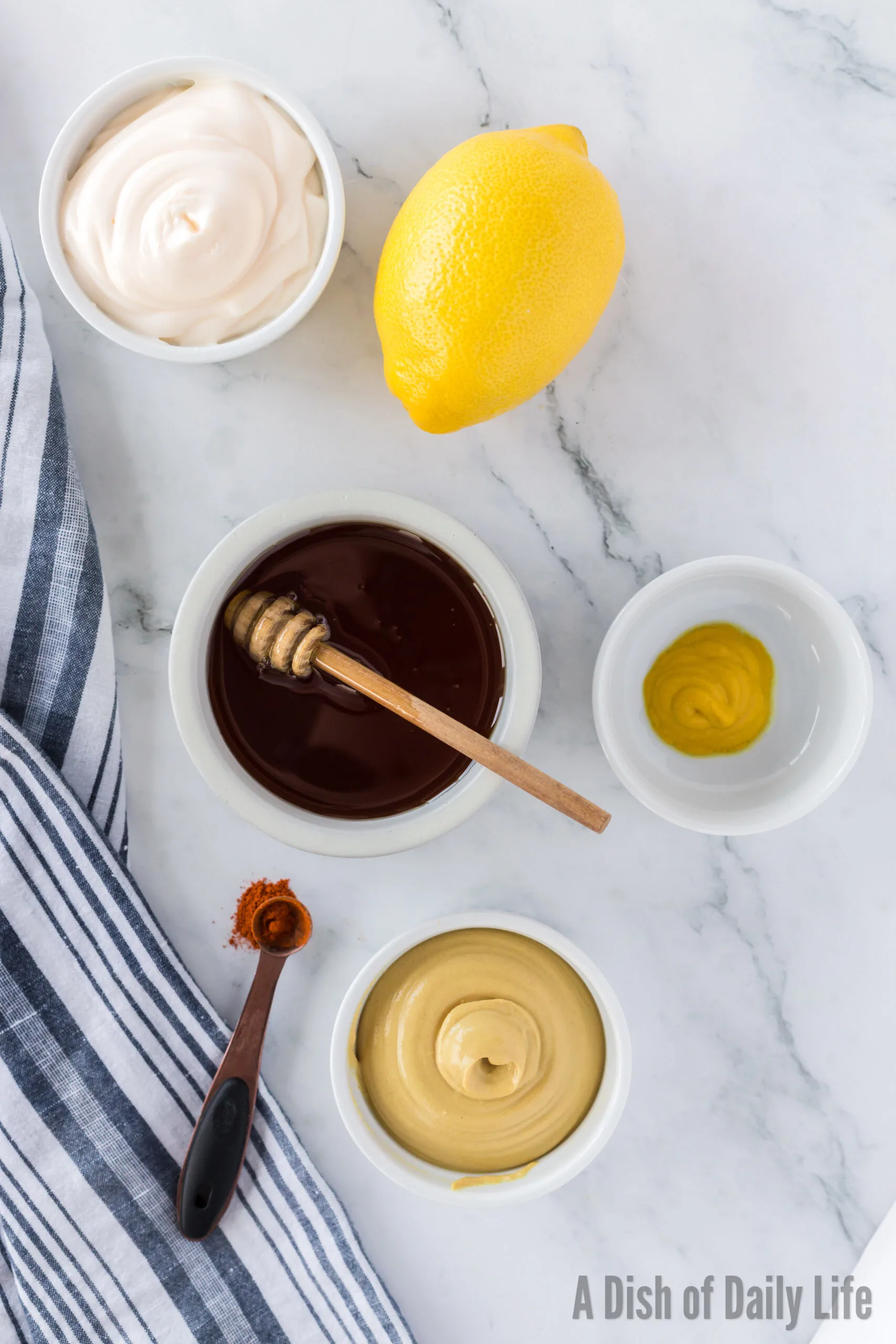 all ingredients for honey mustard dipping sauce laid out on counter