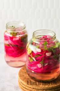 Bright, vibrant onions ready to eat in jars.