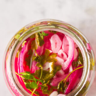 top view looking down at onions in a jar, ready to eat.