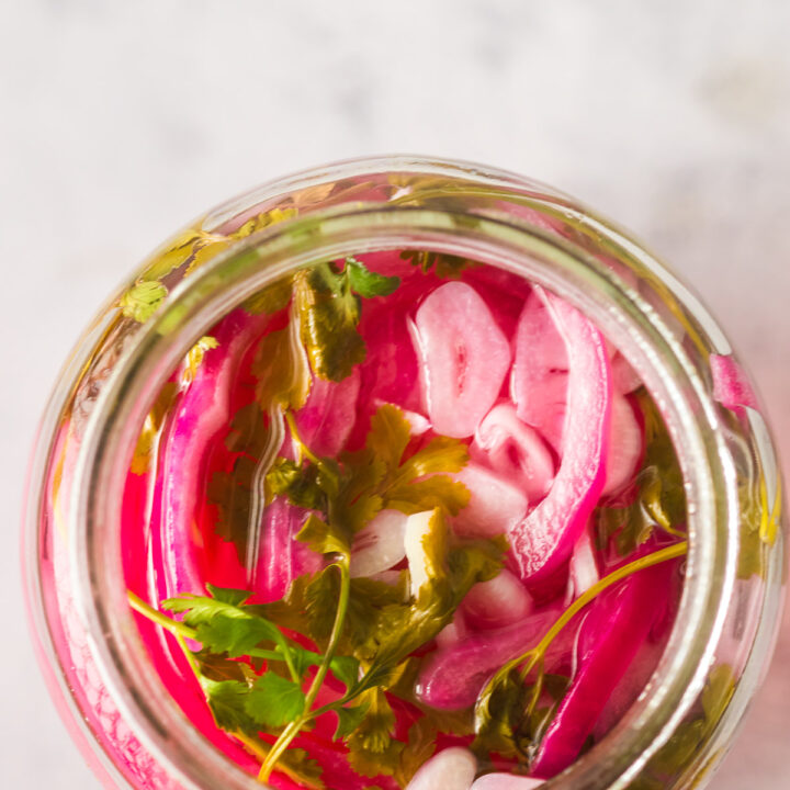 top view looking down at onions in a jar, ready to eat.