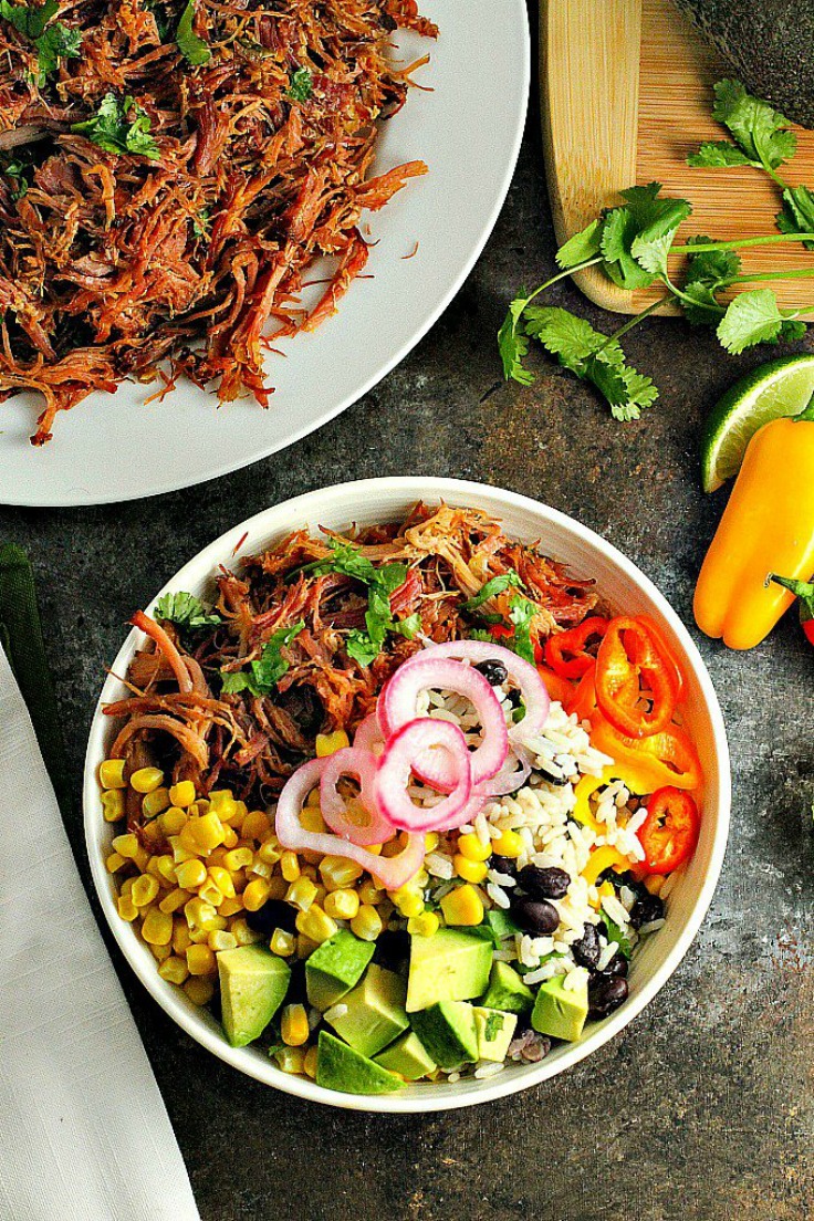 Pork Carnitas Burrito Bowls...Black bean Cilantro Lime Rice topped with flavorful slow cooker pork carnitas and your favorite toppings for a mouthwatering (and healthy) dinner! Perfect for Cinco de Mayo!