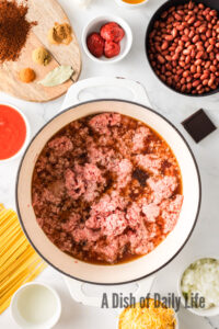 ground beef and broth added to a pot.