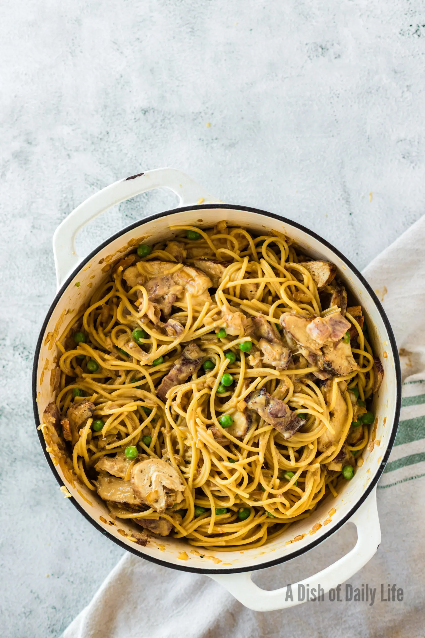 Tossed pasta with chicken in pot, ready to serve