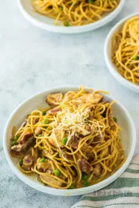 zoomed out image of two bowls of pasta ready to eat