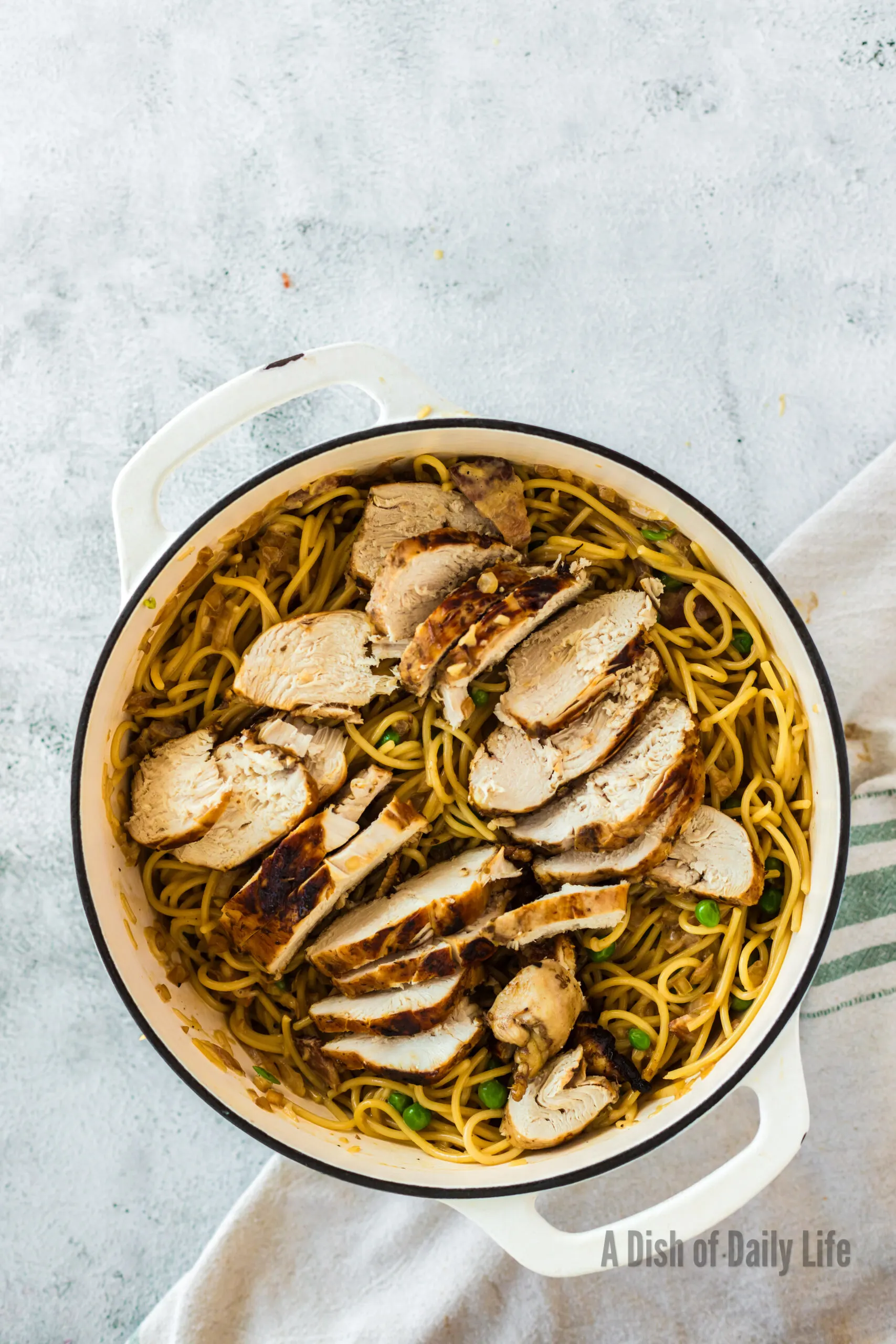 Sliced grilled chicken added to pasta