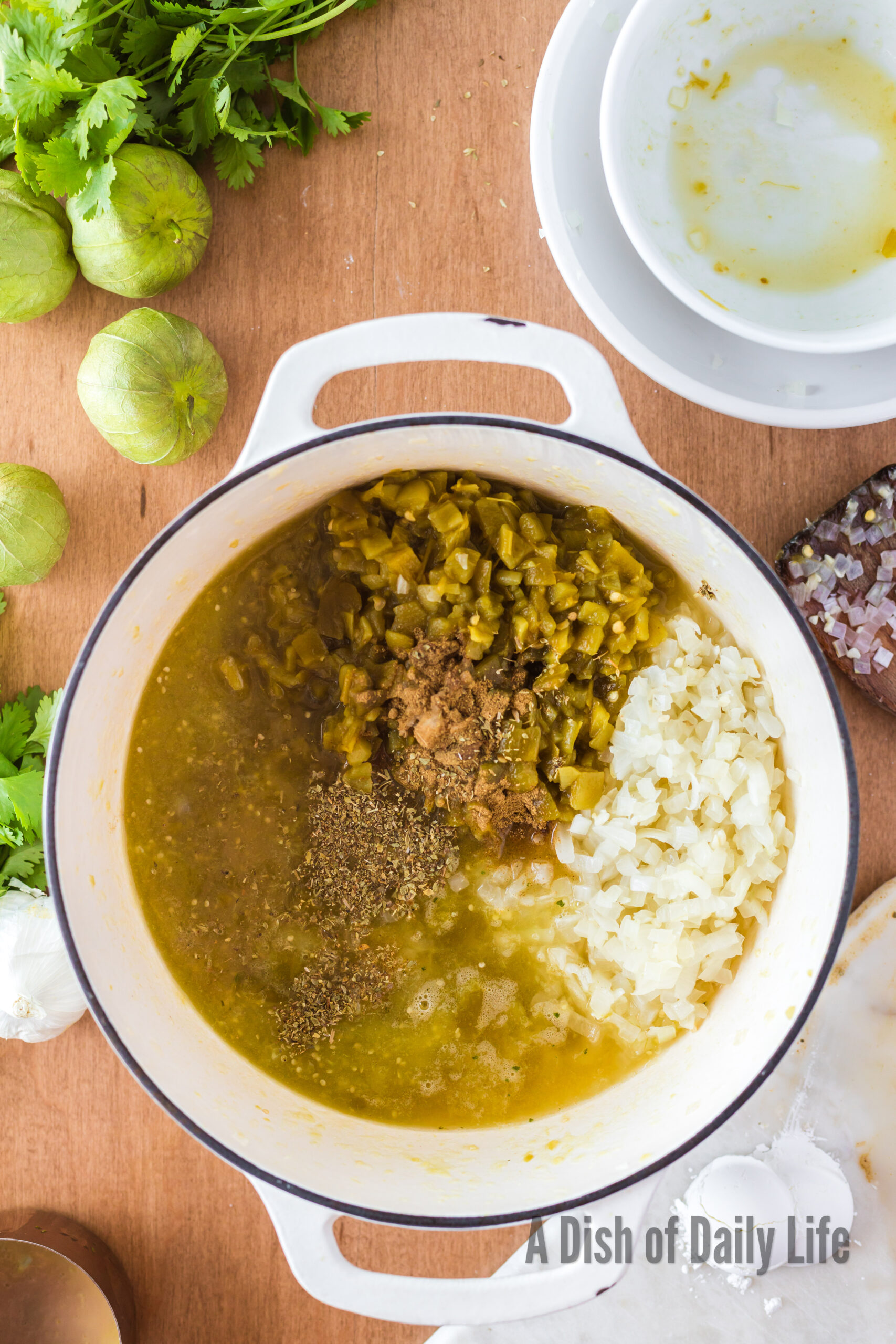 onions, garlic, green chiles, chicken broth, salt, oregano and cumin added to cooked tomatillos