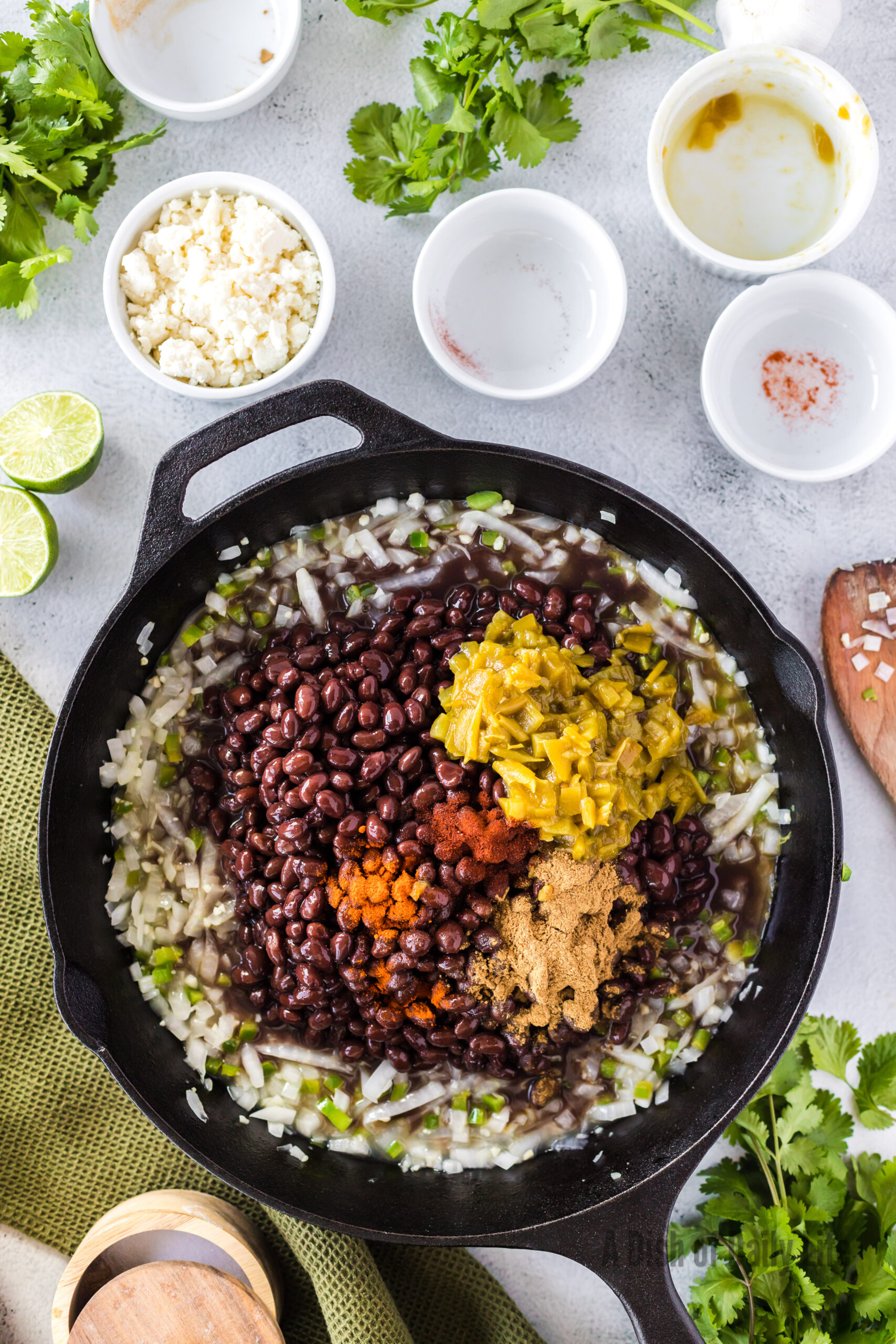 black beans, green chiles, cumin, chili powder and cayenne added to onion mixture.