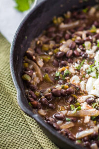 zoomed in image of mexican black beans in skillet