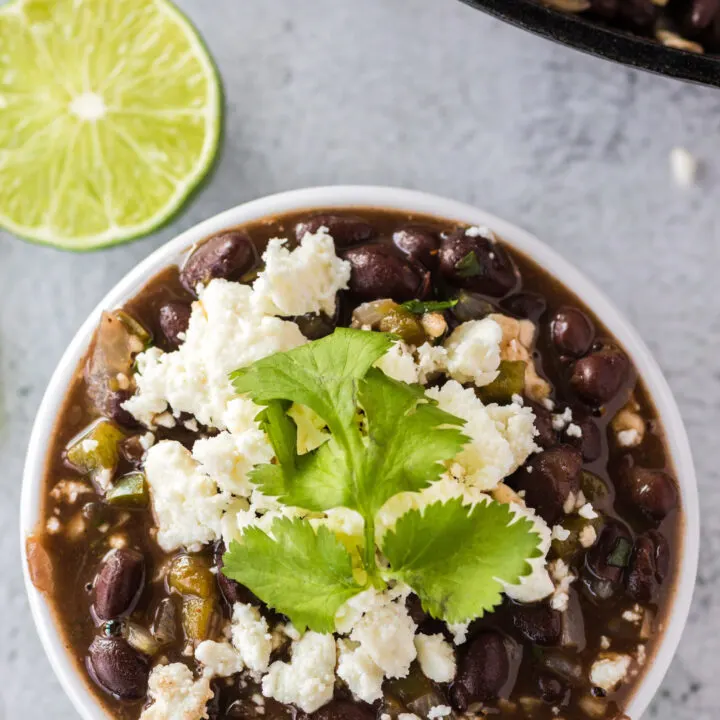 zoomed out image of mexican black beans in a bowl ready to serve.