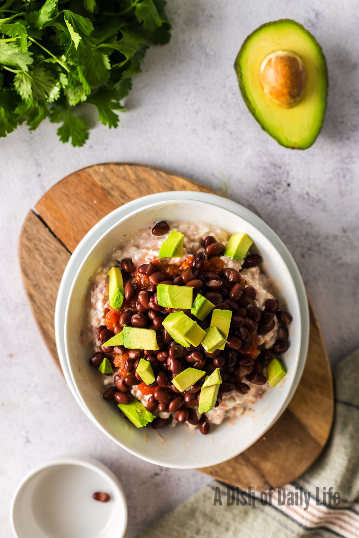 Sliced avocado added on top of black beans