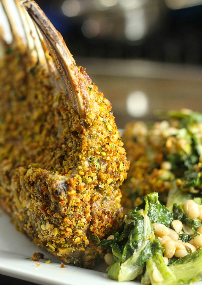 Herb & Pistachio Crusted Lamb Rack with Escarole and White Beans...friends and family will never guess how easy this delicious recipe is to make! If you're looking for a show-stopping main dish for an elegant dinner party menu, this is it!