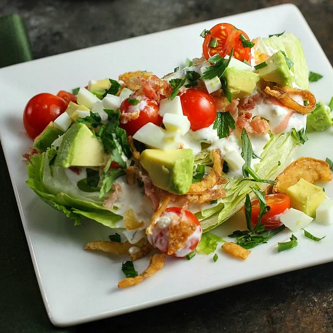 This Wedge Salad is topped with the most AH-MAZING Blue Cheese Dressing in this elegant dinner party menu!