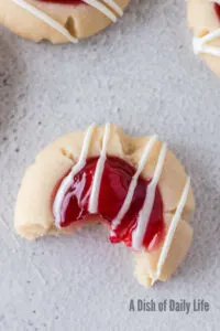 zoomed in image of cherry pie cookie on counter with a bite taken out of it.
