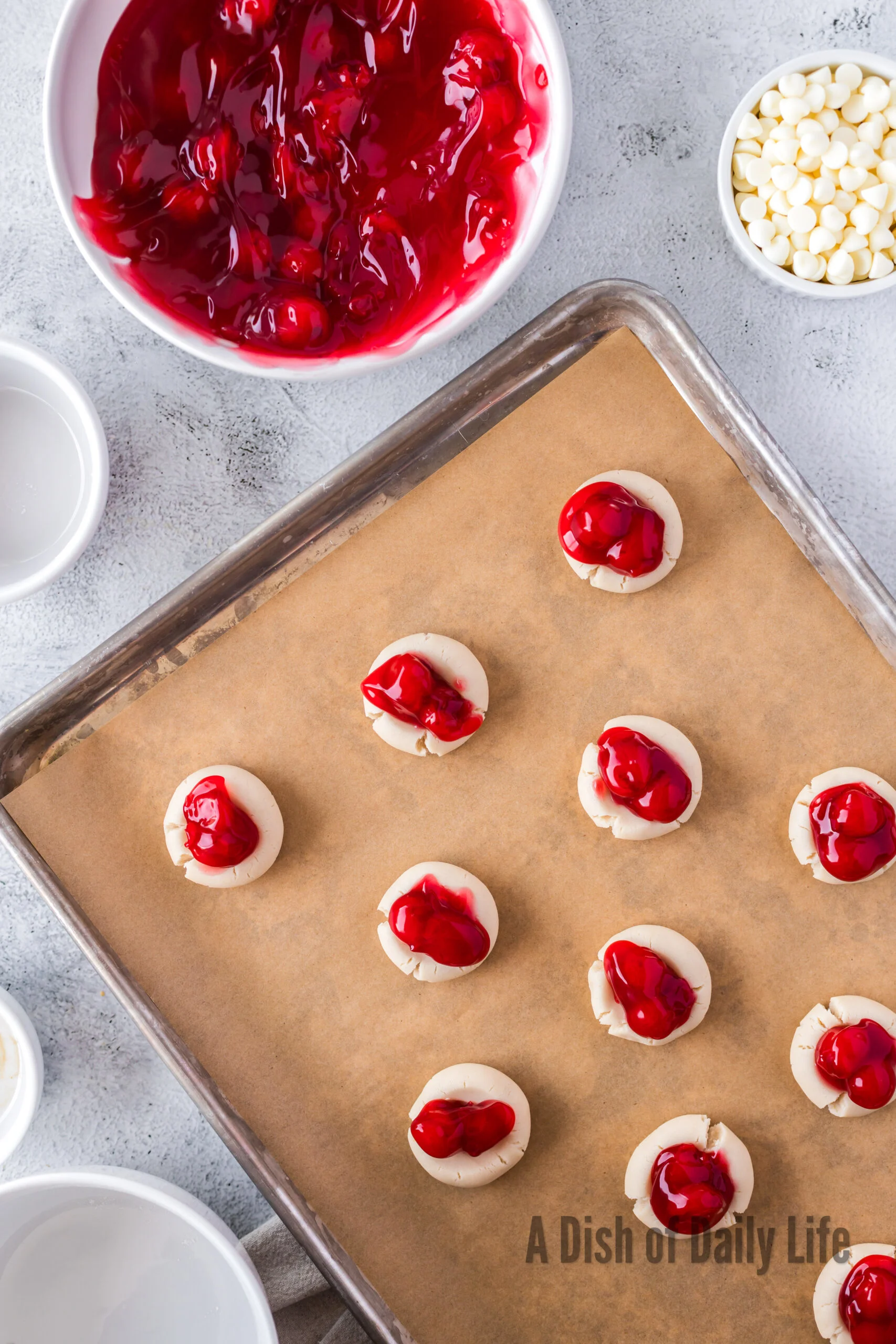 cherry pie filling placed in the center of each cookie