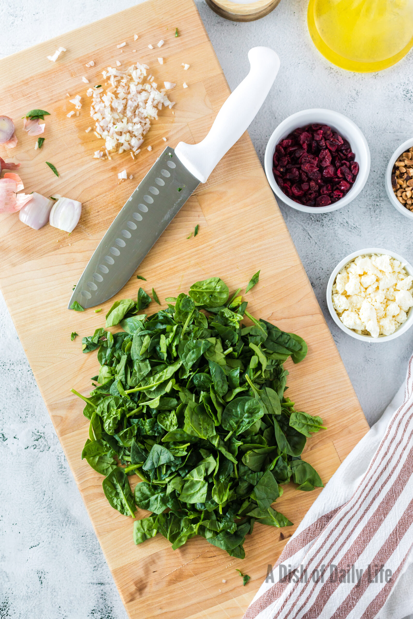 Spinach and garlic minced on cutting board