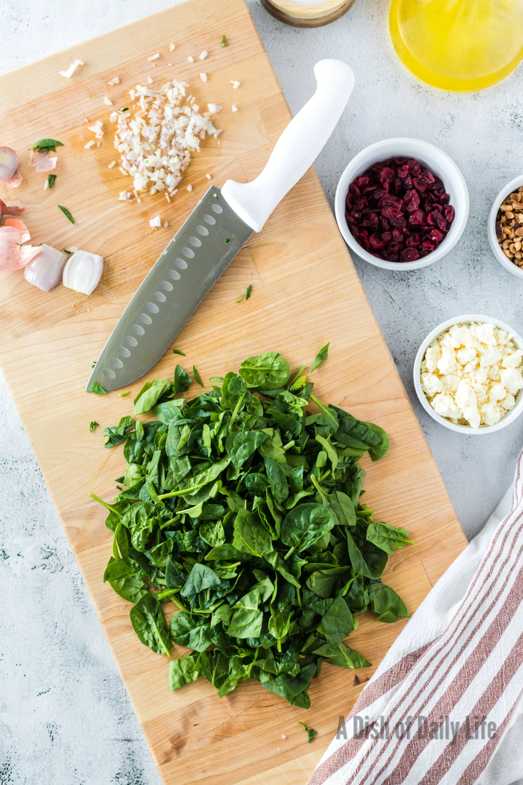 Spinach and garlic minced on cutting board