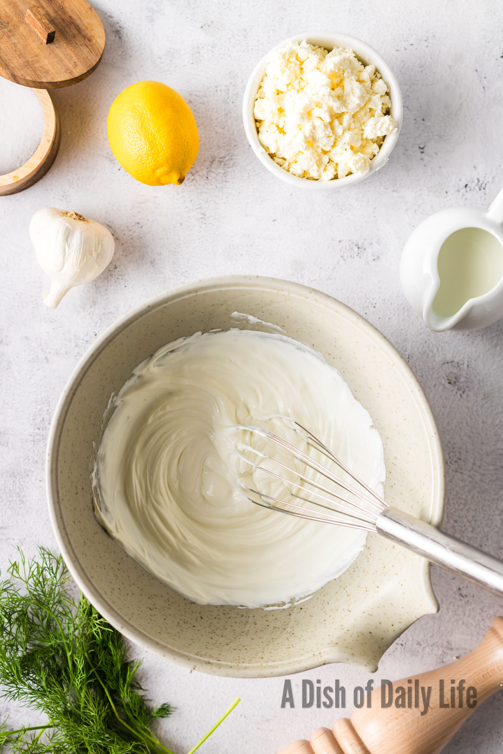 whisked greek yogurt and sour cream in a bowl