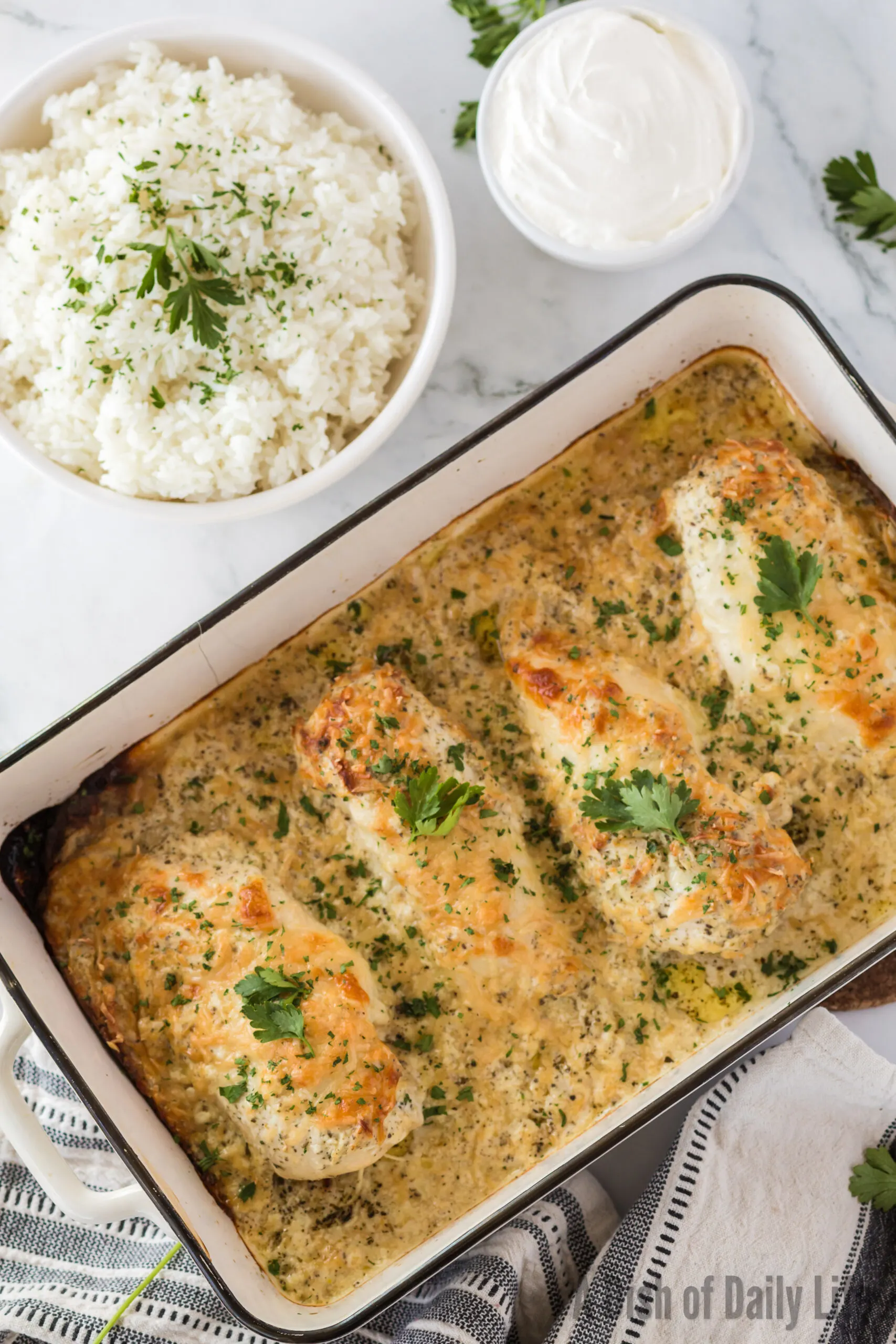 Baked chicken in casserole dish. Casserole dish is tilted to the right.