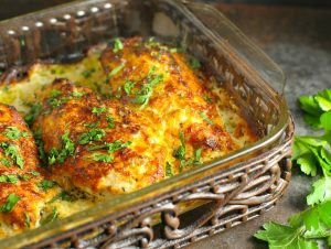 Casserole dish in a serving basket. Chicken baked and sprinkled with parsley.