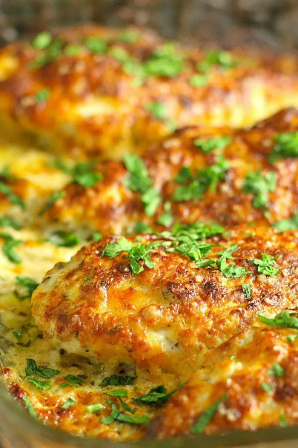 This family friendly Smothered Cheesy Sour Cream Chicken dish is quick, easy, and delicious! There's only ten minutes of prep time and then the oven takes care of the rest! #easydinners #familydinners #chicken