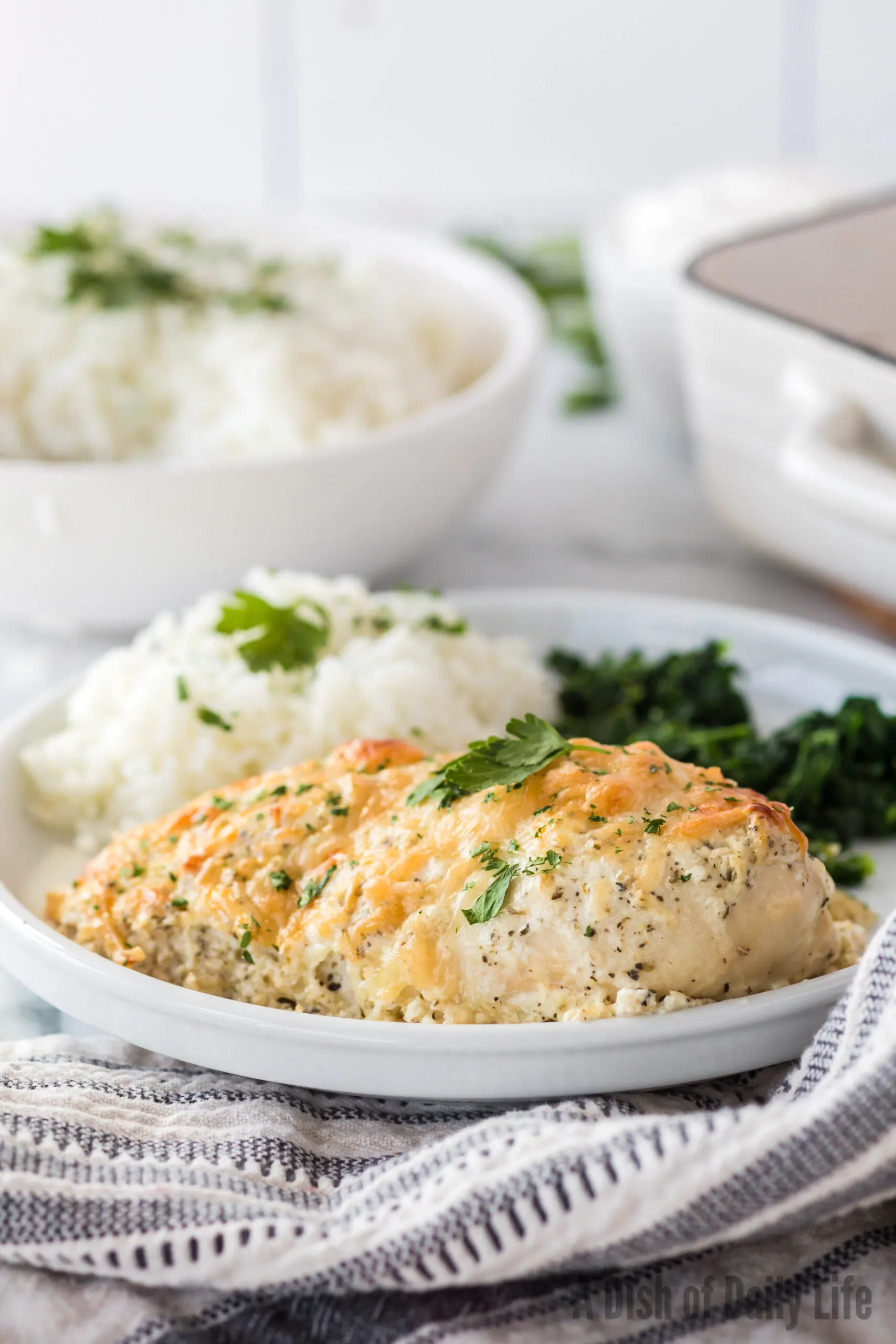 plate of chicken rice and spinach ready to be eaten.