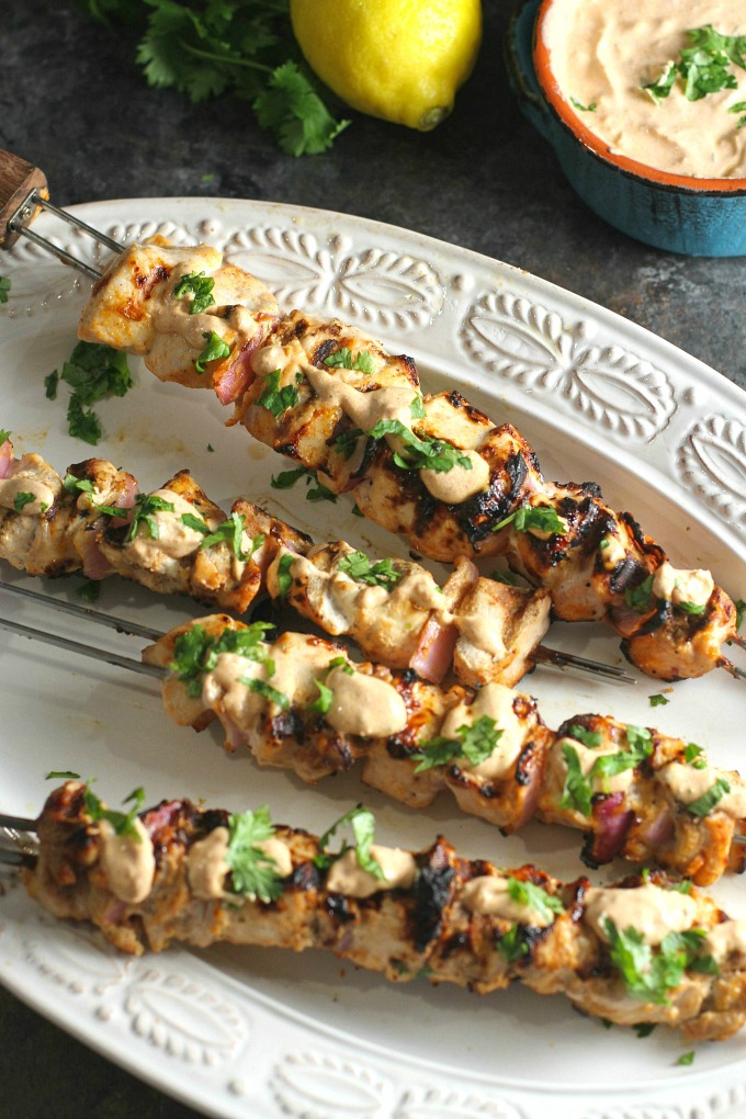 Grilled Chicken Skewers. Marinated in a sour cream sauce with Mediterranean spices, they are so tender and delicious…definitely a crowd pleaser! Save a little of the sauce for dipping after…SO good! #chicken #grilling #easydinner #skewers #kebabs