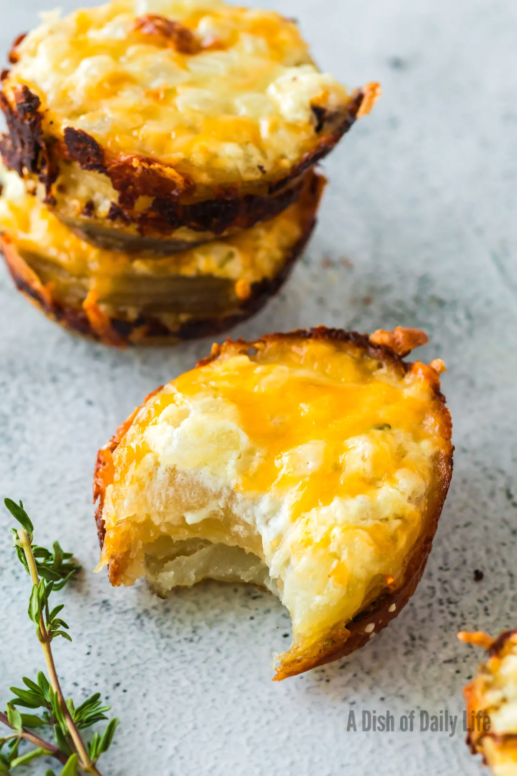 zoomed in image of 3 potato stacks on counter. Two are stacked on top of each other. Third has a bite removed from it.