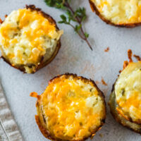 zoomed in image of cheesy potato stacks laid out on counter.