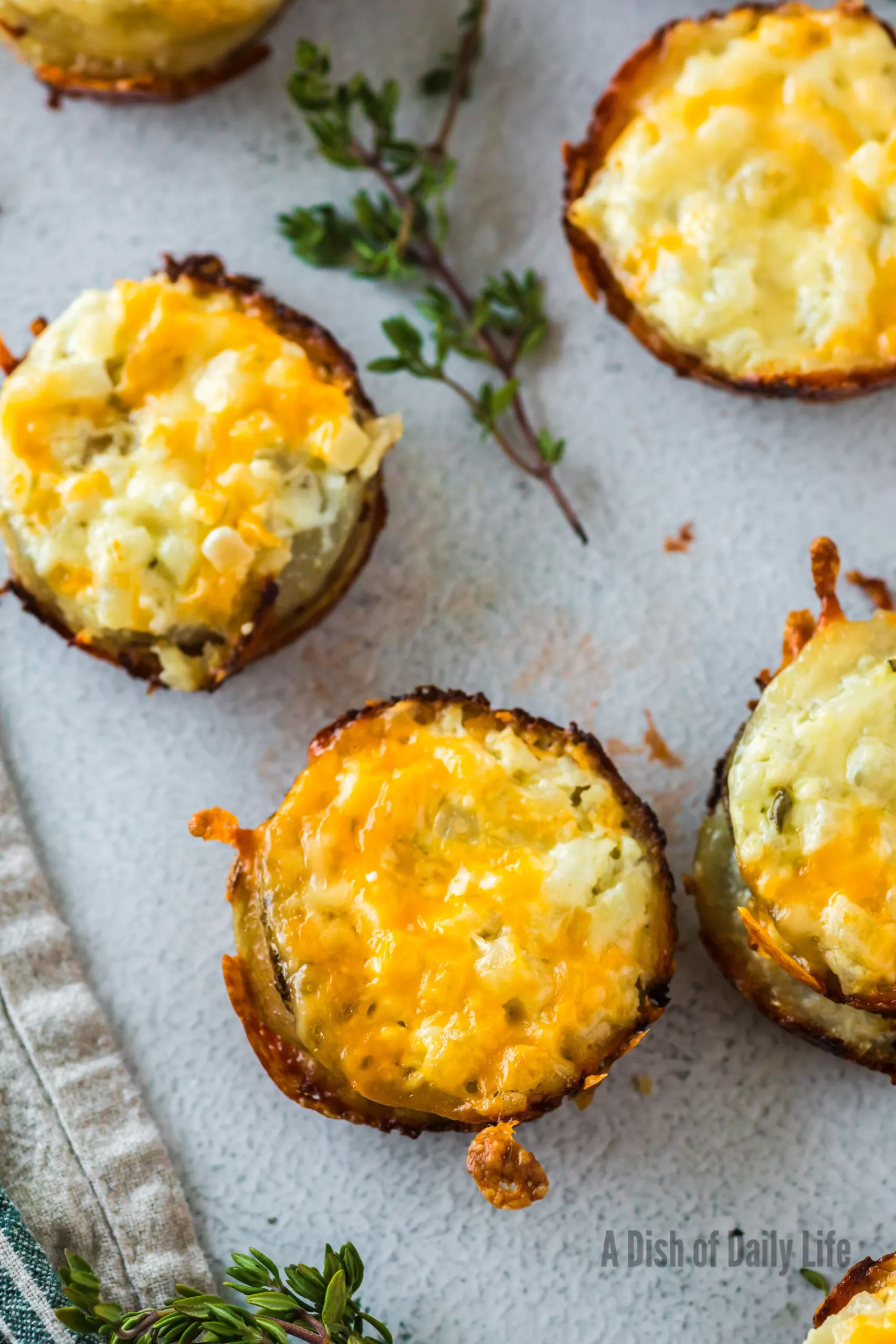 zoomed in image of cheesy potato stacks laid out on counter.