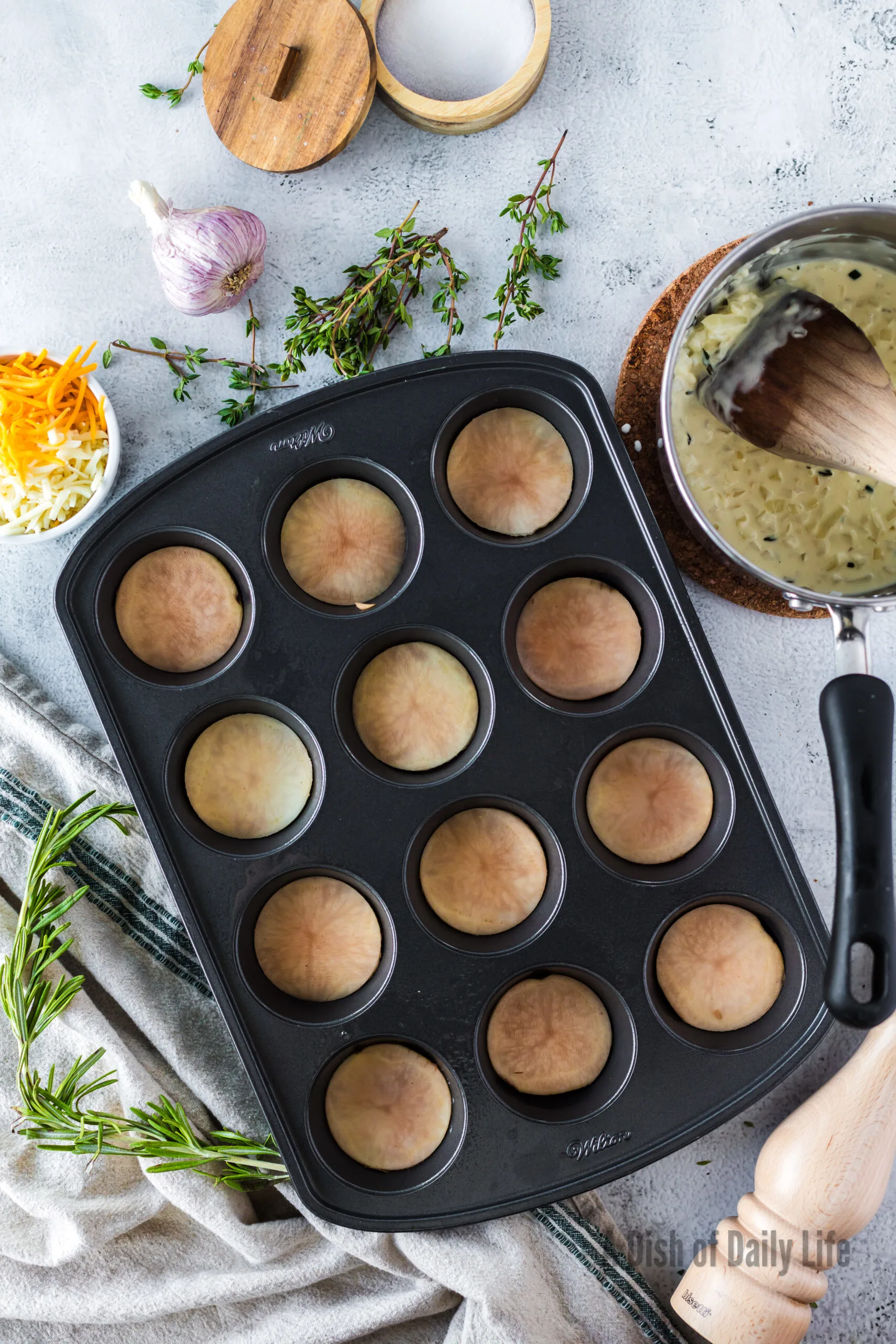 4 potatoes stacked in each muffin tin.