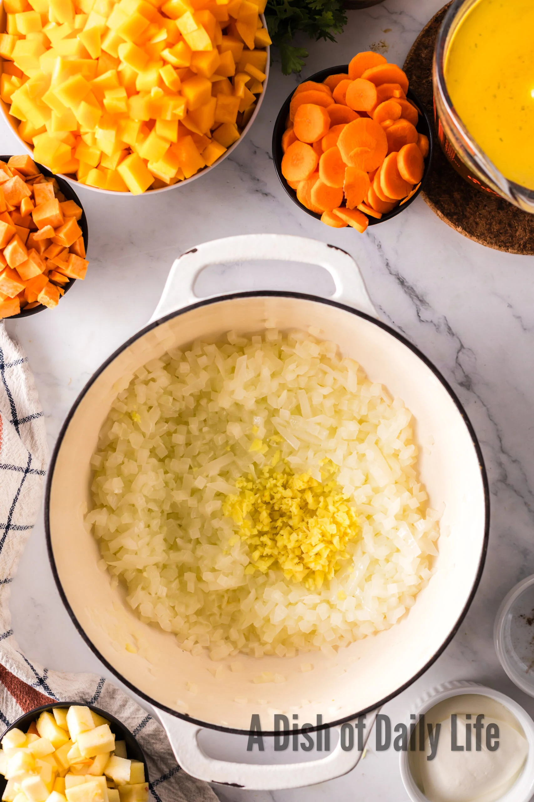 sauteed onions in soup pot with ginger added to it.