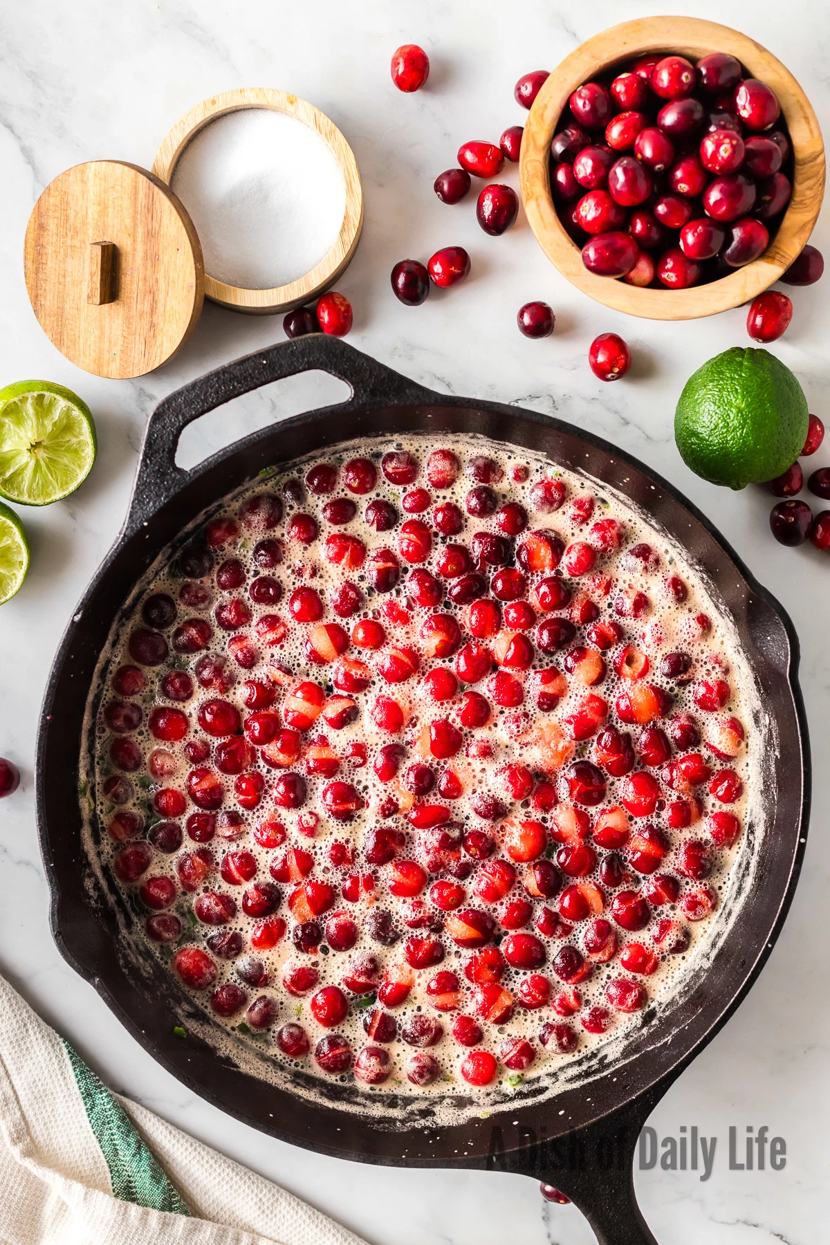 Burst cranberries in jalapeno sauce in skillet.