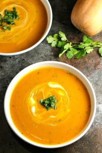 Gingered Butternut Squash Soup…a combination of butternut squash, sweet potato, carrots, and apples, accented by the delicate sweetness of ginger, and finished off with rich, creamy crème fraiche and cilantro. A delicious soup worthy of a special occasion! #butternutsquash #soup #holidayrecipes #Christmas #Thanksgiving