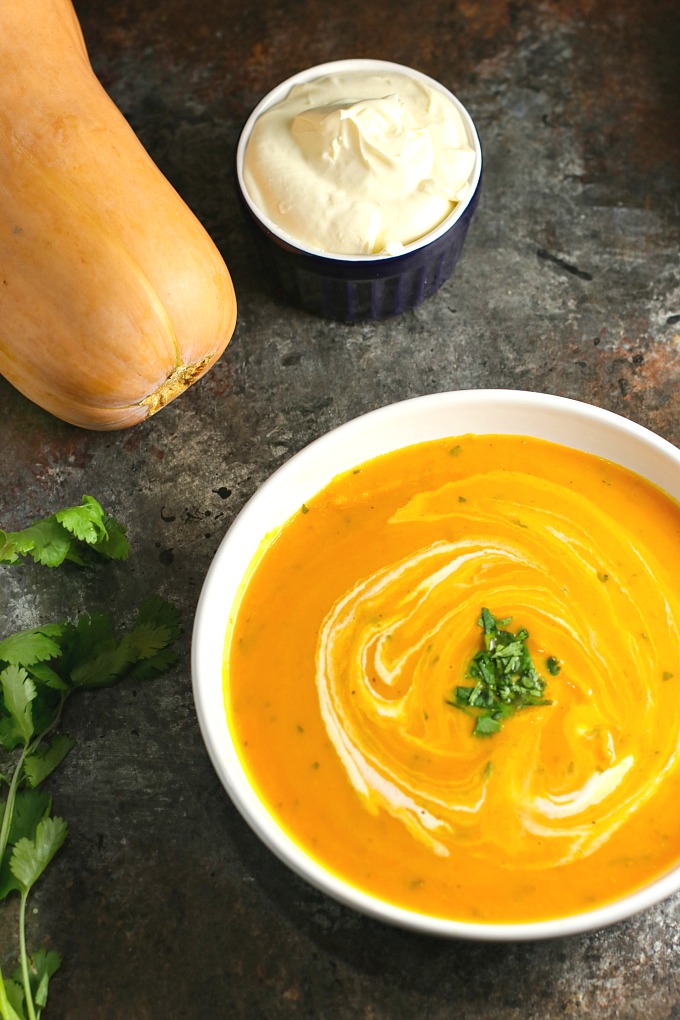 Gingered Butternut Squash Soup…a combination of butternut squash, sweet potato, carrots, and apples, accented by the delicate sweetness of ginger, and finished off with rich, creamy crème fraiche and cilantro. A delicious soup worthy of a special occasion! #butternutsquash #soup #holidayrecipes #Christmas #Thanksgiving 