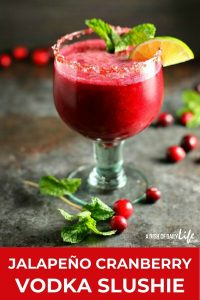 Celebrate the holidays with this Jalapeño Cranberry Vodka Slushie! This fabulous cocktail is tart and sweet, with just a little bit of a kick. It'll be the hit of the party! #cocktail #slushie #cranberry #vodka #holidaycocktails