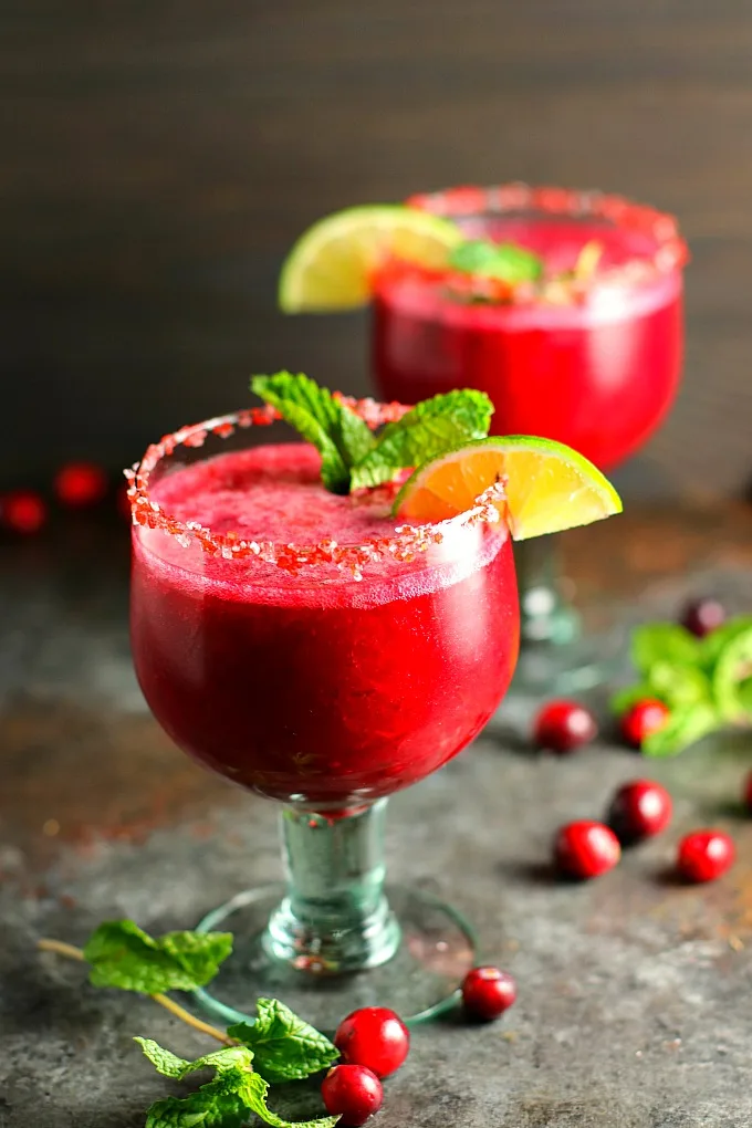 Celebrate the holidays with this Jalapeño Cranberry Vodka Slushie! This fabulous cocktail is tart and sweet, with just a little bit of a kick. It'll be the hit of the party! #cocktail #slushie #cranberry #vodka #holidaycocktails